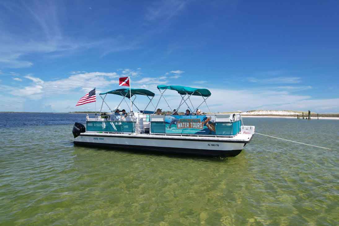 A boat crossing St. Andrews Bay toward Shell Island near Panama City Beach