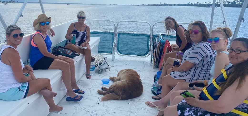 A tour group with a dog on a pontoon